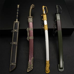 May include: Four decorative miniature swords with sheaths. The swords feature ornate handles and sheaths in various colors, including black, burgundy, gold, and green. The swords are displayed on a dark surface.