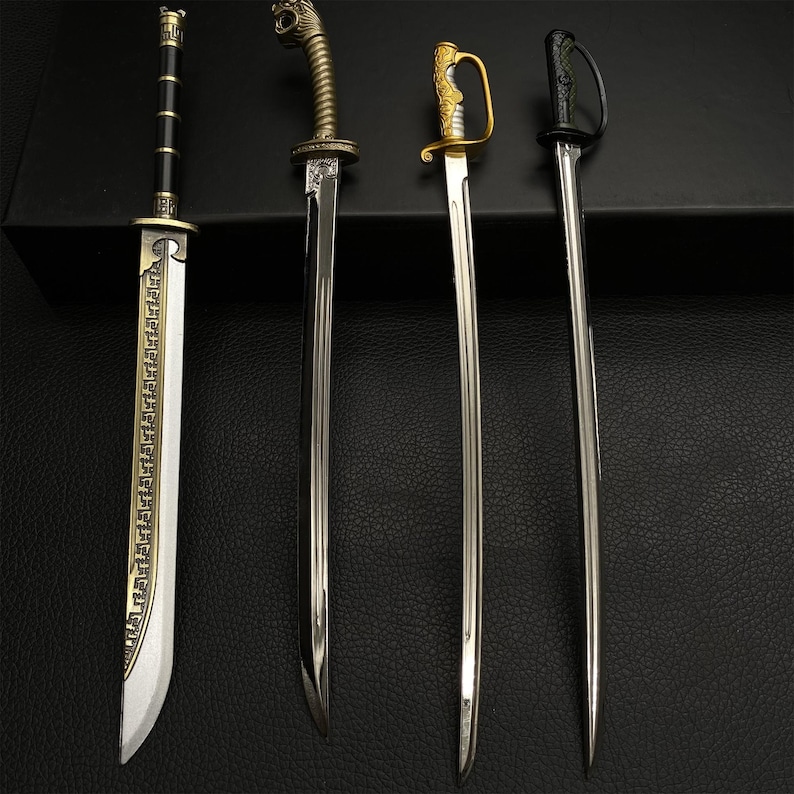 May include: Four decorative swords with ornate handles and silver blades are displayed against a dark background. The swords vary in design, with one featuring a black handle and another a gold handle. The blades are polished and reflect the light.