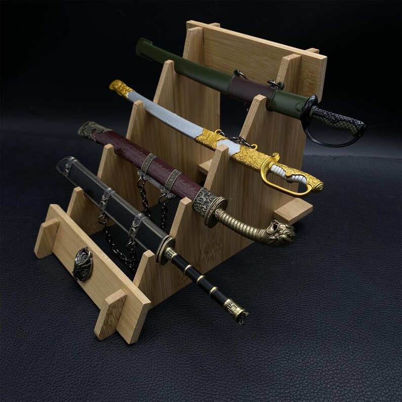 May include: Four decorative swords displayed on a bamboo stand. The swords feature ornate handles and sheaths in various colors, including black, gold, green, and brown. The stand has multiple levels to showcase the swords.