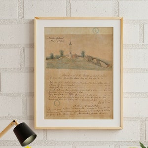 May include: A framed drawing of a building with a tower and a handwritten document. The drawing is on a light brown background with a white border. The document is written in cursive and includes the text "No. 7. Plan of the Ground &c. as it now is." The drawing is hanging on a white brick wall above a wooden desk with a white chair, a lamp, and a clock. There are plants in pots on the desk and on the floor.
