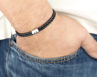 May include: A black leather bracelet with a silver charm that says "K-S".