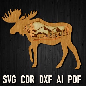 May include: Laser cut wooden moose silhouette with a detailed mountain and forest scene inside. The text "SVG CDR DXF AI PDF" is printed below the moose.