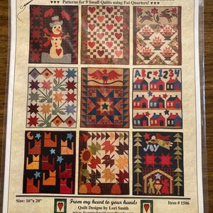 May include: A quilting pattern sheet titled "Fat Quarter Quilting: Throughout the Year." It features nine small quilt patterns with various designs, including a snowman, hearts, and houses. The sheet measures 16" x 20".