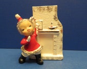 Ucagco Pixie Girl Wearing Santa Suit Holding Candy Cane Candy Cane Holder or Planter - Stands Beside Fireplace w Candle and Clock on Mantle