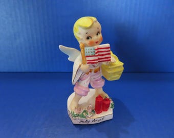 Lefton July Angel - He is Holding a Flag in One Hand with Picnic Basket on His Arm - Ready to Celebrate Independence Day! Wonderful & Rare!