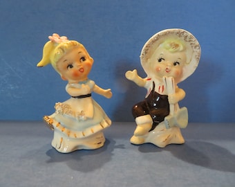 Enesco Gardening Boy and Girl  Salt & Pepper - Pink Flower in Hair Holding Her Hands Out to Him - Boy Holding Shovel - Both w Spaghetti Trim