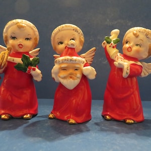 Fine A Quality Christmas Angel Trio - Set of Three - Each Wears Santa Hat - Holding Santa Face,  Candy Cane Filled Stocking & Gold Horn
