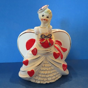 R/B Valentine Planter Beautiful Blonde Girl Standing by Heart Shaped Planter Wearing a Gold Embellished Gown w Dimensional Red Hearts