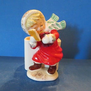 HF Japan Christmas Girl Candy Cane Holder Walking Against the wind on a Snowy Cold Day with a Present in Each Hand - Lovely Detail