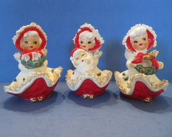Norcrest Christmas Girls - Set of 3 - Holding Santa, Wreath or Present - Red & White Cape Adorned w Holly Gold Highlighted Spaghetti Trim