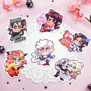 May include: Set of nine colorful cartoon character stickers featuring various characters with different expressions and poses. The stickers are printed on white paper and have a glossy finish.