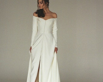 Modern off-shoulder wedding dress with a slit Off-the-shoulder long sleeve crepe bridal gown Minimalist button front wedding gown  SERENA