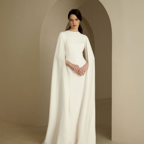 Cape sleeve wedding dress Minimalist crepe wedding dress Elongated sleeves wedding dress Modern fit&flare bridal gown with a slit ADELINE Cape sleeve wedding dress Minimalist crepe wedding dress Elongated sleeves wedding dress Modern fit&flare bridal gown with a slit ADELINE