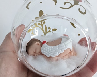 glass or plastic ball with miniature baby angel to personalize