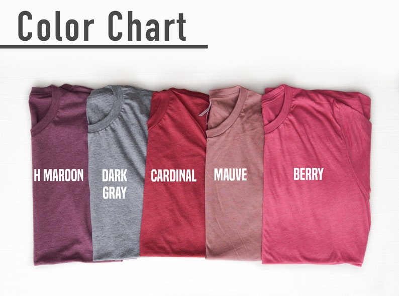 May include: A color chart displaying five folded t-shirts in various colors: H Maroon, Dark Gray, Cardinal, Mauve, and Berry. The text "Color Chart" is at the top. The shirts are arranged on a white surface.