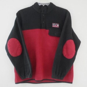 May include: Black and red fleece pullover with a button-up collar, two patch pockets, and elbow patches. The shirt has the text "Tommy Hilfiger" and "TH - ER" on the front.