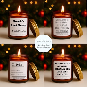 May include: Four lit candles in brown glass jars with gold lids. Each candle has a label with humorous text. The labels read: "Sarah's Last Nerve", "Our friendship is like this candle...", "Olivia", and "Having me as a friend is really the only gift you need."