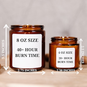 May include: Two amber glass candles with white labels. The larger candle is 3.5 inches tall and 2.75 inches wide, labeled "8 OZ SIZE" with "40+ HOUR BURN TIME." The smaller candle is 2.5 inches tall and 2.38 inches wide, labeled "4 OZ SIZE" with "20+ HOUR BURN TIME."
