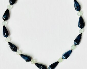 Italian torpedo blue beads with navy stone nestled in a sterling silver pendant.