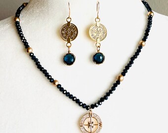 Navy rondelle crystals with gold compass and earrings to match.