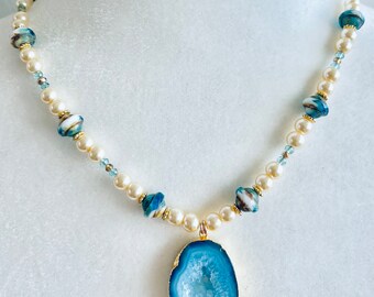 Teal, yellow and gold beads accent this beautiful teal druzy geode. Makes such a statement!