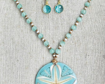 Made by me this Aqua blue sandollar pendant and earrings