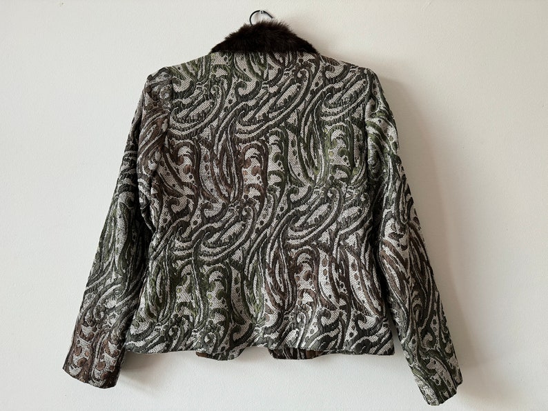 K&ouml;nnte beinhalten: Eine braune und gr&uuml;ne Jacke mit Paisley-Muster und einem Kunstfellkragen.
