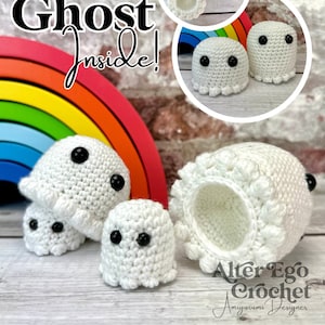 May include: White crochet ghost figures with black button eyes. The image includes several sizes of ghosts, some with open tops, and the text "Ghost Inside!" on a rainbow background. The design is by Alter Ego Crochet.