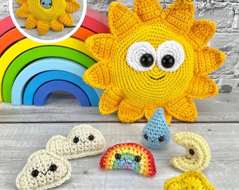 May include: A set of crocheted amigurumi toys including a yellow sun, a rainbow, a cloud, a moon, a star, and a raindrop. The toys have smiling faces and are arranged on a wooden surface. The text "Surprise Inside!" is written below the toys.