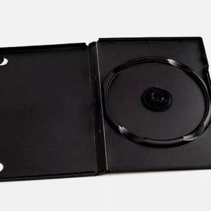 May include: Black DVD case with a clear plastic disc holder. The case is open and the disc holder is visible.