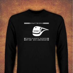 May include: Black long-sleeved t-shirt with a white graphic of a train and the text "Kraftwerk Trans Europe Express 1977-2017 40th Anniversary"