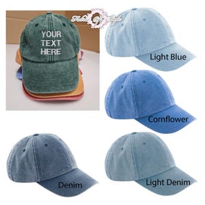 May include: A collection of six baseball caps in various colors including dark green, light blue, cornflower blue, denim, and light denim. The dark green cap features the white embroidered text YOUR TEXT HERE on the front panel. Each cap has a curved brim.