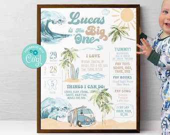 May include: A colorful printable first birthday chart for a boy named Lucas. The chart features a blue and green watercolor wave, palm trees, a surfboard, and a blue van. The chart includes information about Lucas's age, height, weight, teeth, favorite things, and things he can do.