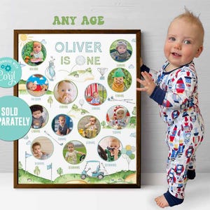 May include: A white poster with a green, brown, and blue golf course theme. The poster says "Oliver is one" and has 16 photo spaces for pictures of a baby. The poster is framed in a brown frame.
