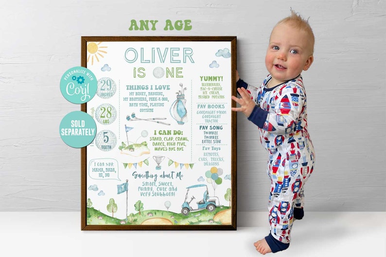 May include: A personalised printable chart for a one-year-old boy named Oliver. The chart features a golf theme with a green and white colour scheme. It includes details like his height, weight, favourite things, and a fun fact about him. The chart is framed in a brown wood frame.