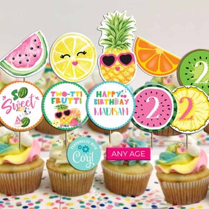 May include: A set of 10 cupcake toppers featuring a fruit theme. The toppers include a watermelon, lemon, pineapple, orange, kiwi, and a number 2. The toppers are perfect for a birthday party.