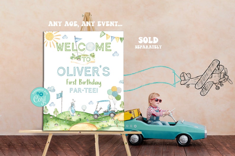 May include: A white welcome sign with a green golf course theme. The sign reads "Welcome to Oliver's First Birthday Par-Tee!" with a cartoon golf cart and golf clubs. The sign is on an easel and a child is driving a toy car in front of it.