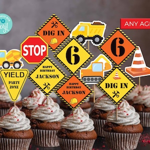 May include: Construction themed cupcake toppers with yellow, orange, and black signs that say "Dig In", "Stop", "Yield Party Zone", "Happy Birthday Jackson", and "6". There are also images of a construction truck, a backhoe, and a traffic cone.
