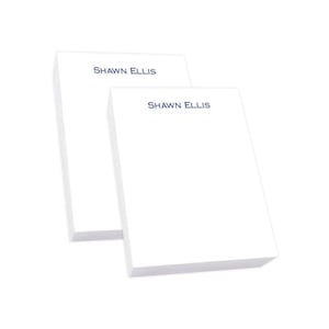May include: Two white notepad sets with the name "Shawn Ellis" printed in blue on the top of each notepad.