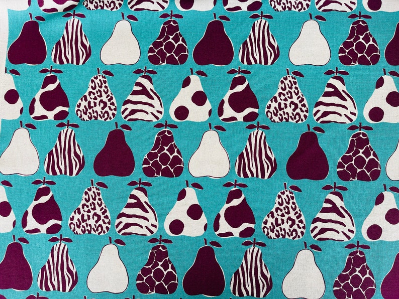 May include: A turquoise fabric with a repeating pattern of pears. The pears are in various colors and patterns, including white, brown, black, and leopard print.