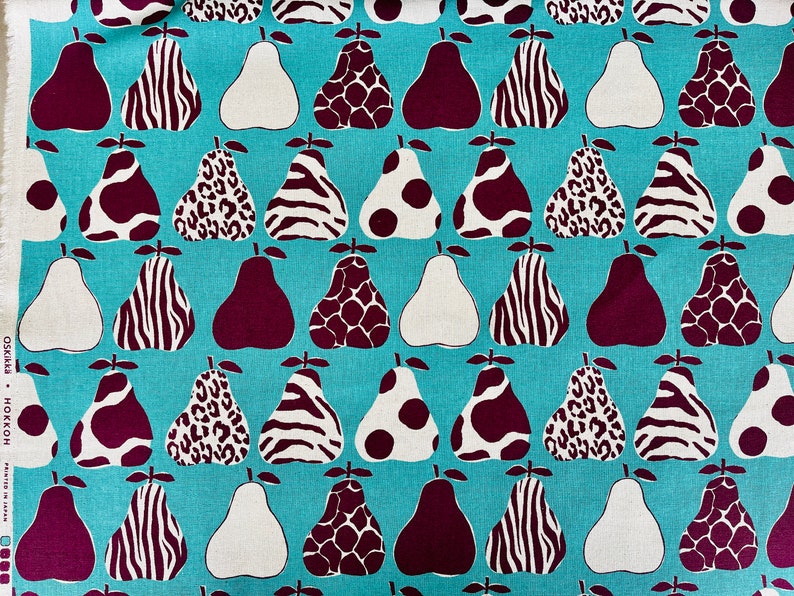 May include: Teal fabric with a repeating pattern of pears. The pears are in various designs, including leopard print, zebra print, polka dots, and solid colors. The pears are in shades of brown, white, and black.