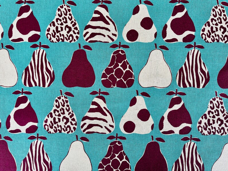 May include: A turquoise fabric with a repeating pattern of pears. The pears are in various patterns, including zebra stripes, leopard spots, and polka dots. The pears are in shades of white, brown, and burgundy.