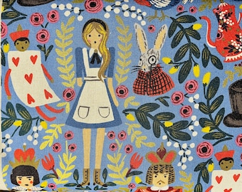 May include: A blue fabric with a whimsical Alice in Wonderland design. The fabric features illustrations of Alice, the Mad Hatter, the Queen of Hearts, the White Rabbit, and a teapot. The fabric is covered in a repeating pattern of flowers, leaves, and other whimsical details.