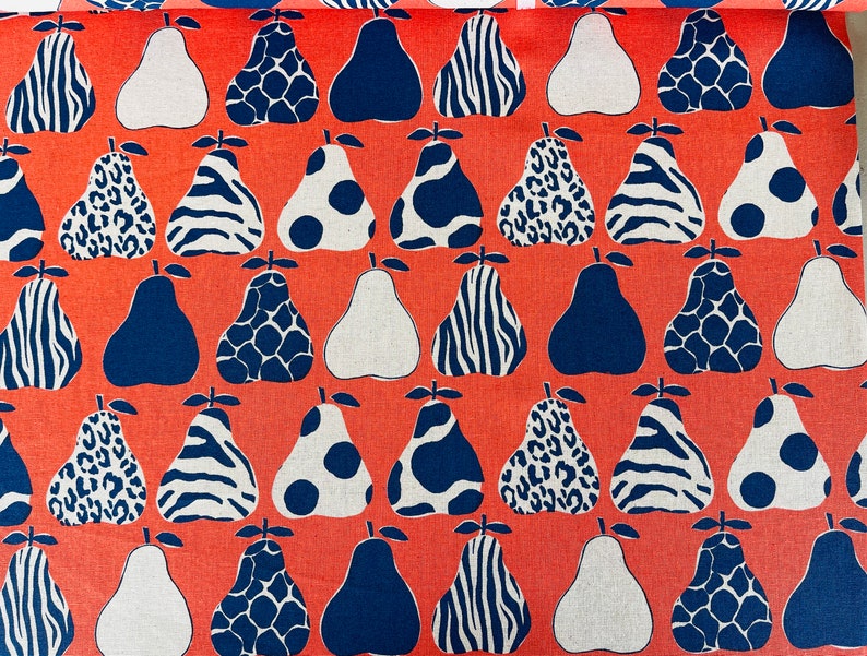 May include: A coral orange fabric with a repeating pattern of pears. The pears are in various designs, including zebra stripes, leopard spots, polka dots, and a geometric pattern. Some pears are white, some are blue, and some are a combination of white and blue.