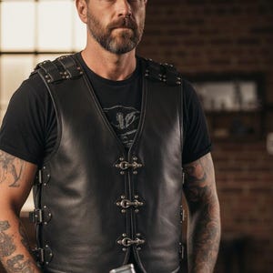 Man wearing Harley Davidson style biker vest next to custom chopper