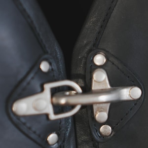 Metal buckle and rivet detail on Harley Davidson style vest