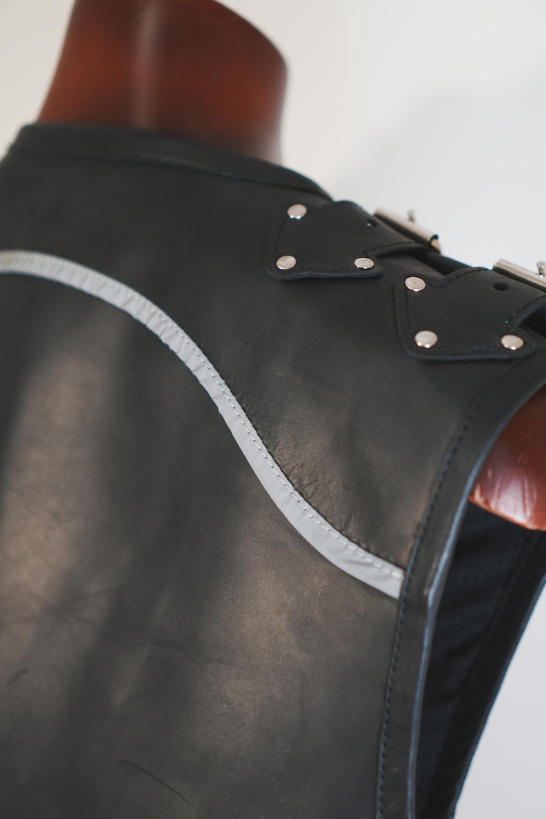Shoulder buckle detail on handmade black leather biker vest