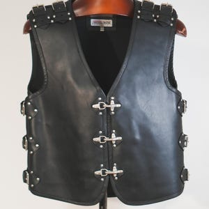 Back view of men’s black leather motorcycle vest with reflective piping