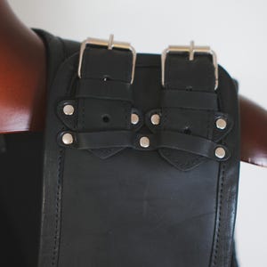 Shoulder buckle detail on handmade black leather biker vest