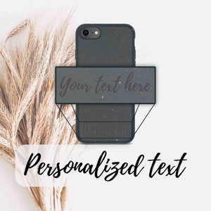 May include: A black phone case with a textured surface. The case has a white rectangle with the text "Your text here" on it. The text is in a cursive font. The case is on a white background with wheat stalks.